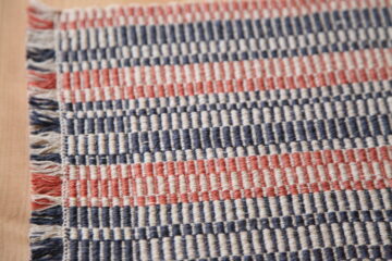 Table Runner, 2022, 9" x 32", Cotton and linen handwoven table runner with orange, blue, and white. Made on a shaft loom.